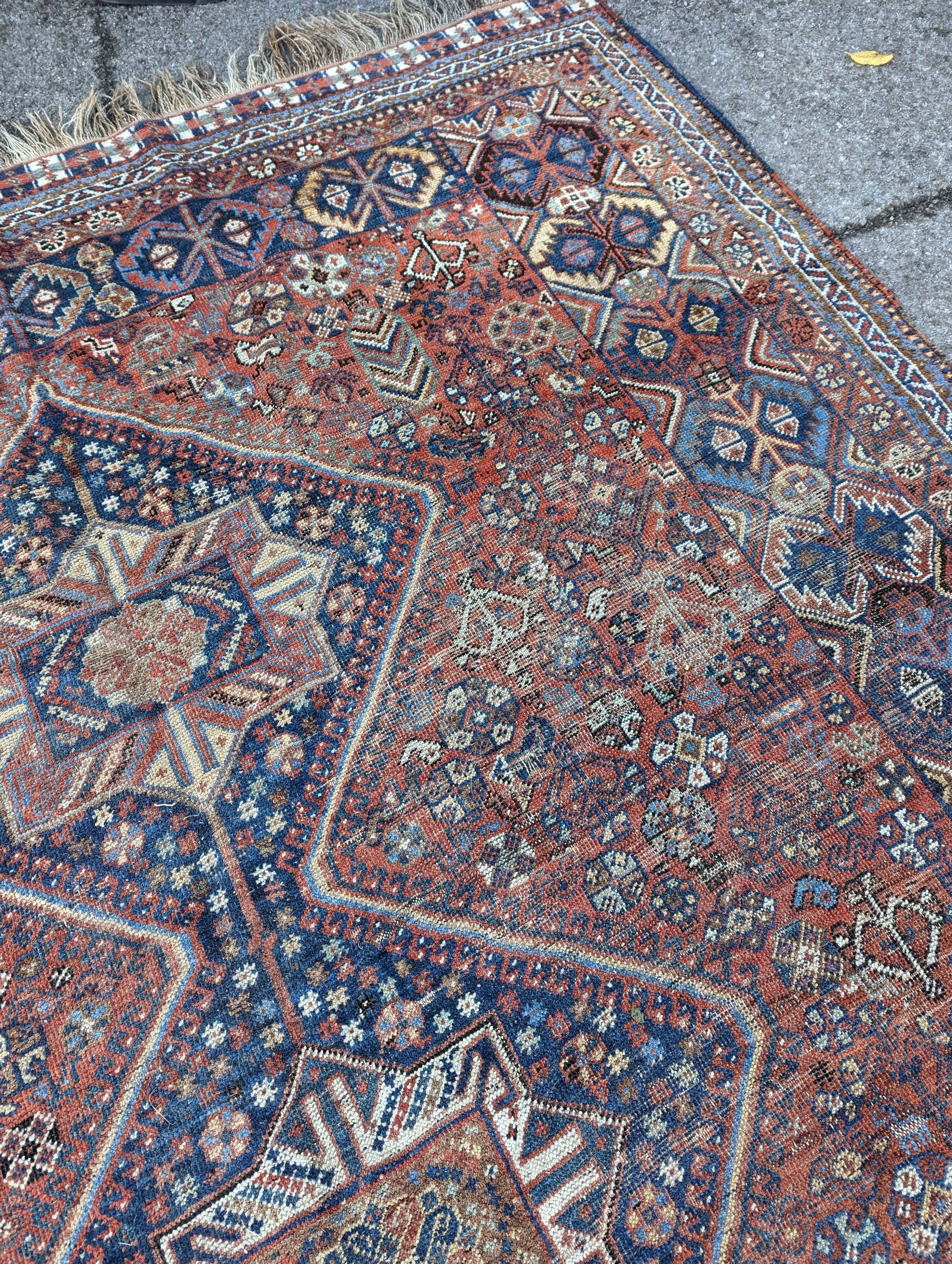 A Caucasian red ground carpet, 295 x 220cm